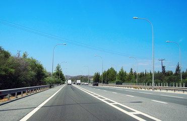 Fototapeta na wymiar Motorway in Cyprus. Bright sunny summer day with blue clear sky