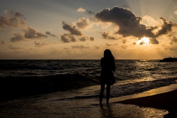 Fototapeta premium Alone and sad at the beach before sunrise silhouette style