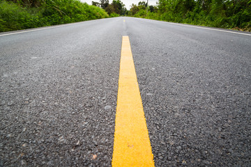 Empty asphalt road through the agricultural fields