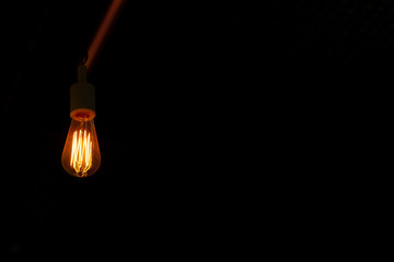 Dark background with glass retro-bulb Edison. Wallpapers with designer lamp of Edison. Designer...