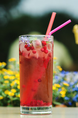 Summer cold drink outdoor. Red freshment drink with cowberry and fresh lavender at cafe terrace. Water detox with cowberry.