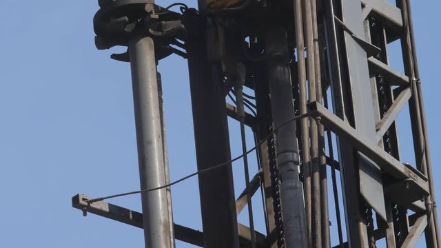 Drilling rig in the coal open pit. Drilling holes for explosives in the quarry. Slow motion, 4k, 60fps. Close up
