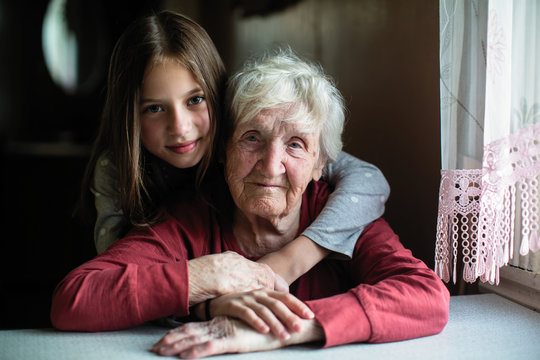 Elderly woman with her little granddaughter.