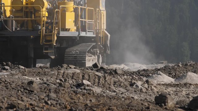 Drilling rig in the coal open pit. Drilling holes for explosives in the quarry. Slow motion, 4k, 60fps