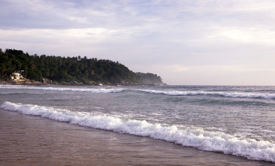Beautiful sunset on Karon beach. The surf pounds the shore. Phuket, Thailand