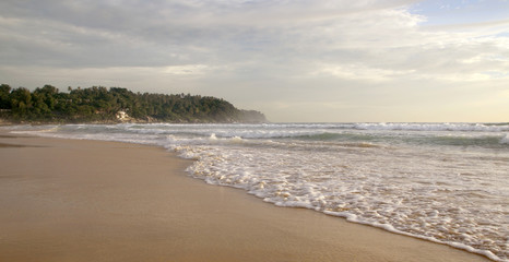 Obraz premium Beautiful sunset on Karon beach. The surf pounds the shore. Phuket, Thailand