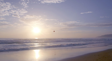 Fototapeta premium Beautiful sunset on Karon beach. The surf pounds the shore. Phuket, Thailand