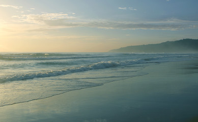 Beautiful sunset on Karon beach. The surf pounds the shore. Phuket, Thailand