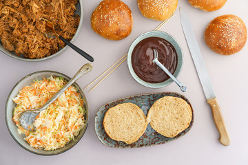 Making pulled pork burgers with homemade burger buns, pulled pork and coleslaw