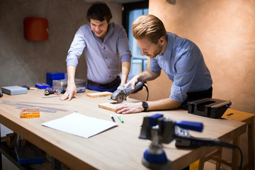 Two creative designers working in workshop