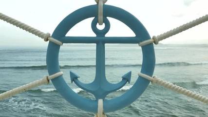 Sailor sign of anchor made of iron at sea beackground