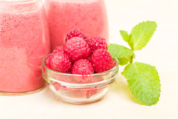 Raspberry smoothie close up photography with fresh summer blended cocktail and ripe berries.