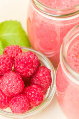 Raspberry smoothie close up photography with fresh summer blended cocktail and ripe berries.