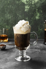 Irish coffee with whisky on dark background