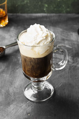 Irish coffee with whisky on dark background