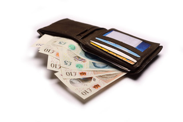 Pound sterling in wallet on isolated white background