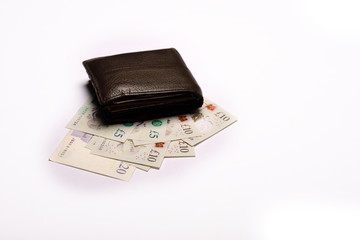 Pound sterling in wallet on isolated white background