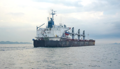 Cargo Ship in the sea with cloudy background