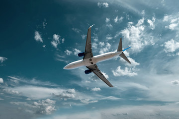 Airplane at fly on the sky with clouds