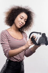 Dark-haired woman. Image without face retouching with curly dark-haired woman wearing striped shirt...