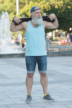 Energetic Senior Man Enjoying Riding A Skateboard