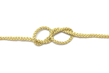 close up of gold rope on white background