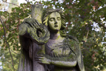 Fototapeta na wymiar Historic Statue on the mystery old Prague Cemetery, Czech Republic