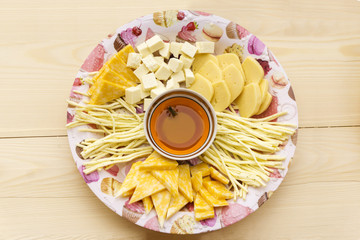 wasp in a plate of honey, standing in the middle of a dish with cheese sliced