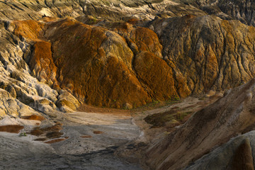 landscape - a fragment of a quarry of kaolin mining with beautiful slopes with traces of streams