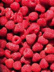 Perfect fresh and sweet red raspberries, food background. Healthy food organic nutrition. Rubus idaeus fruit. Bright natural delicious background of many pile ripe juicy fragrant raspberry berries