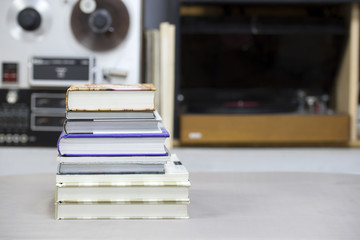 Book, stack of hardback books on table. Top view.