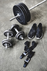 Obraz na płótnie Canvas various weight lifting equipment on concrete surface