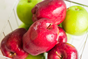fresh red apple and green apple in basket