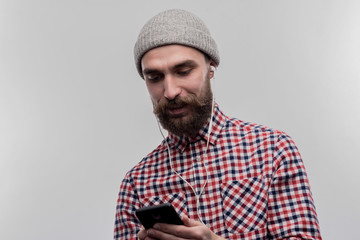 Man with hat. Stylish bearded young businessman wearing grey hat on his head on image without face...
