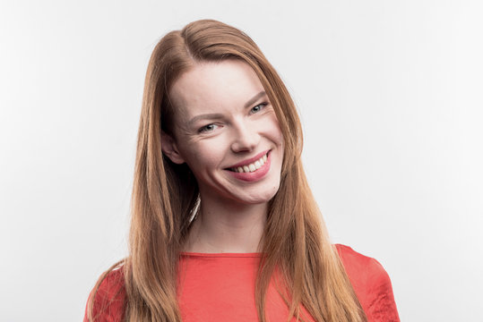 Beaming woman. Beaming red-haired woman with facial wrinkles smiling broadly on image without face retouching