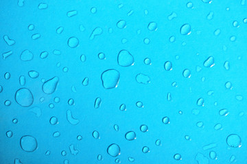 Water drops on blue glass background