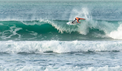 Surfer riding crest of wave, Fistral beach, Newquay, Cornwall
