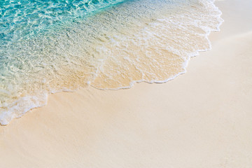 Fototapeta na wymiar Inspirational beach scene, empty beach sand and soft waves splashing