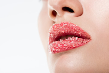 cropped view of woman with sugar on pink lips, isolated on white