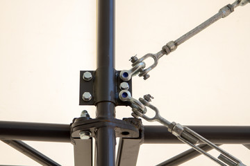 A complex connection of metal exterior structures: loop, hinged, screw. Connection with studs and steel ropes.