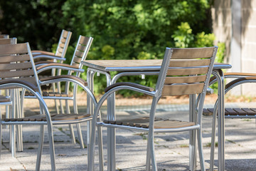 Empty contemporary tables and chairs outside a bar restaurant. Outdoor furniture.