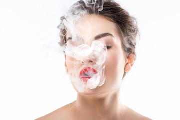 beautiful woman blowing smoke, isolated on white