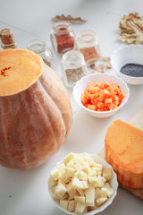 Ingredients and spices for pumpkin soup preparing on the table