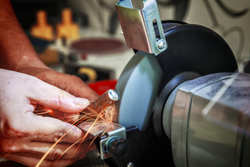 Close-up of sharpening the steel billet on the grinding machine