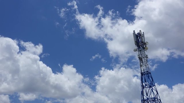 Video timelapse of technology station connection, tower signal or antenna tower. Royalty high-quality free stock timelapse footage of tower signal in blue sky white clouds background