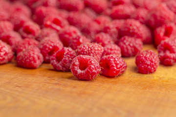 Raspberry fresh and sweet on wooden background close up
