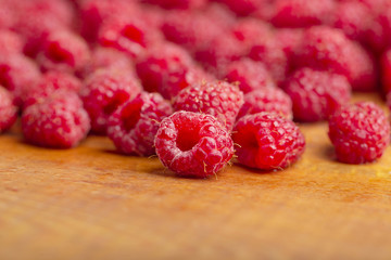 Raspberry fresh and sweet on wooden background close up