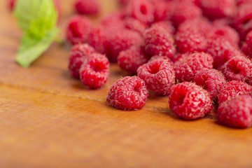 Fresh raspberry with mint on wooden background