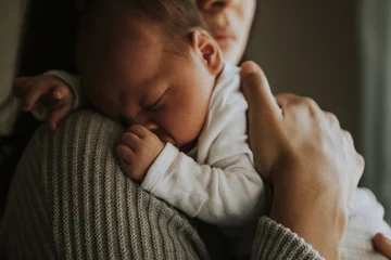 Foto op Plexiglas Mother holding her baby indoors © Rawpixel.com
