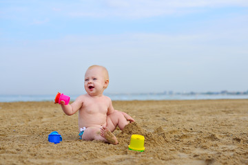 Girl on the beach playing with sand